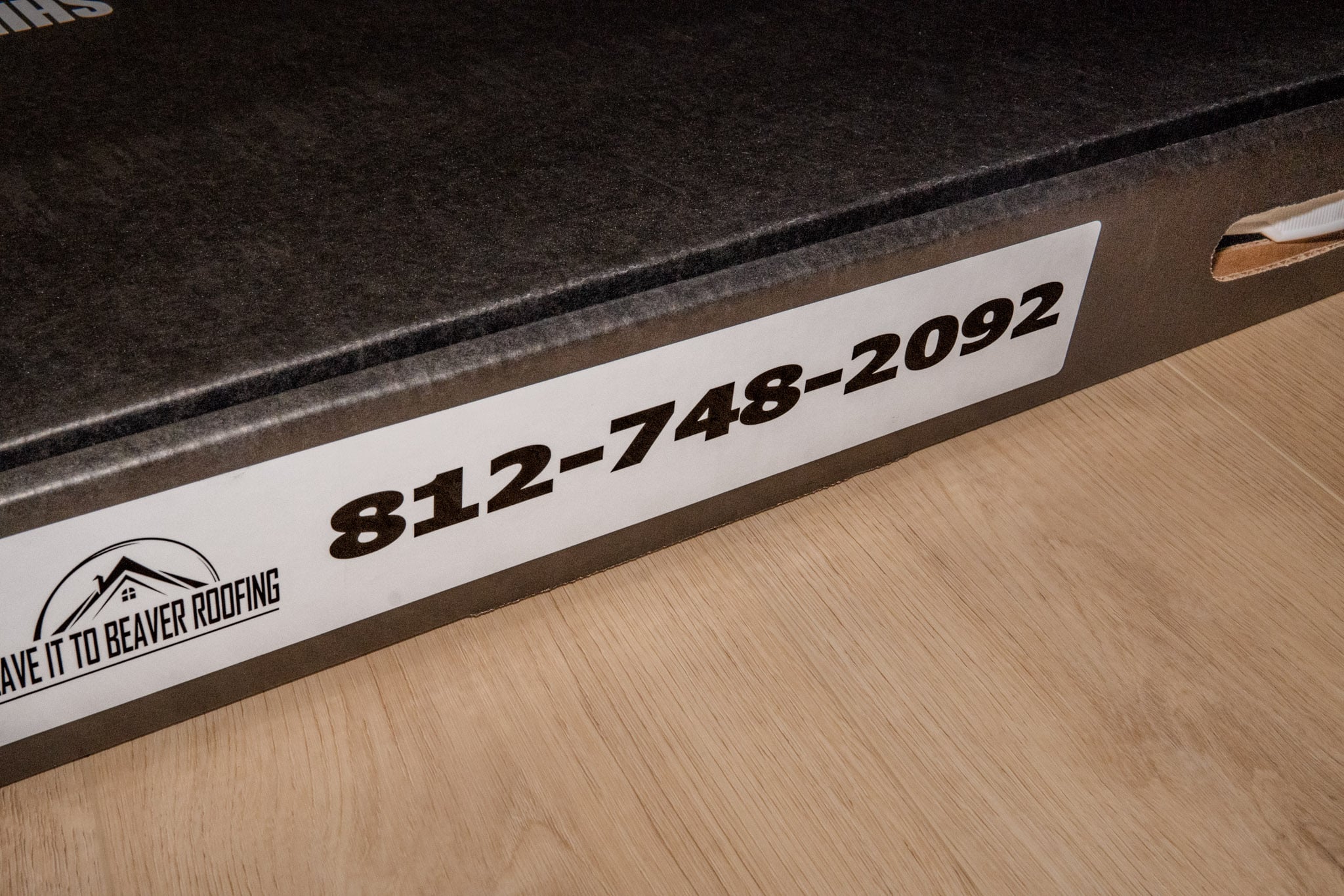 Phone number placement on shingle tomb box